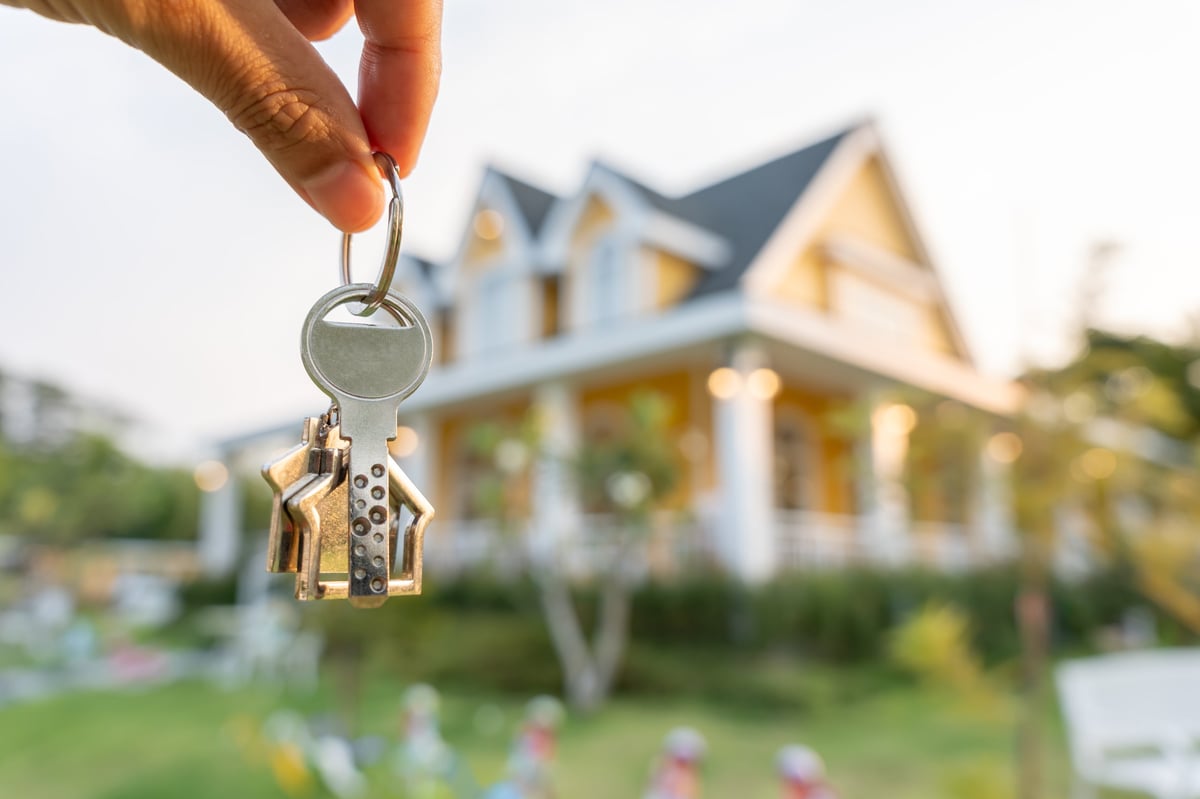 Real estate agent handing the keys of a new home to its owner